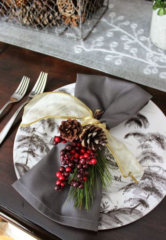 yellow ribbon, berries, twigs and pinecones for a lush rustic place setting