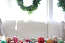 15 a primitive dough bowl filled with colorful vintage ornaments