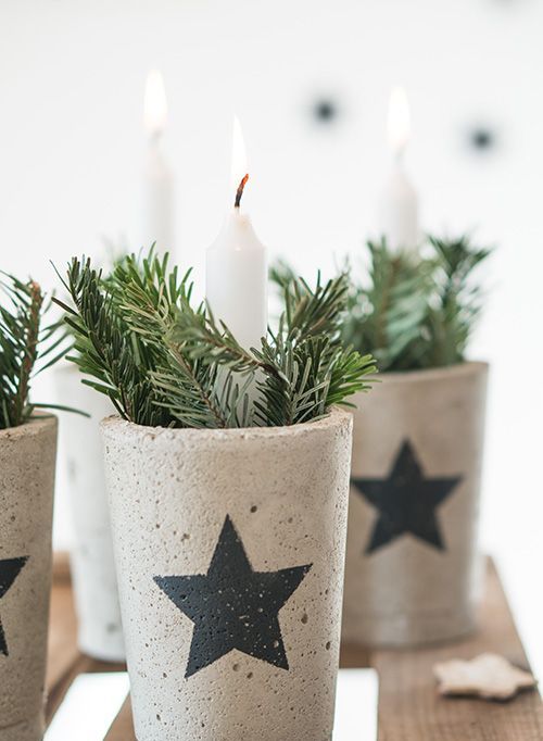 concrete pots with stars filled with evergreens