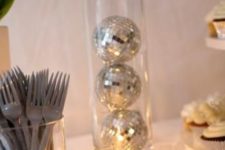 15 make a centerpiece with a vase and disco balls inside