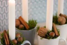 16 cups with greenery, cinnamon sticks, nuts and candles