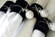 18 black velvet napkin rings with silver ornaments attached