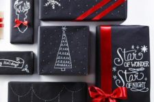 18 black wrapping paper decorated with a white sharpie pen and red ribbon