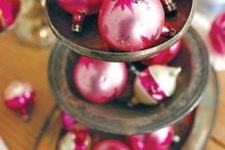 18 pink Christmas ornaments display on an antique cupcake stand
