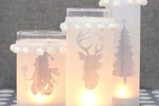 20 silhouette Christmas candle lanterns decorated with pompom trim