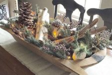 21 a vintage display with pinecones, berries, branches and skis