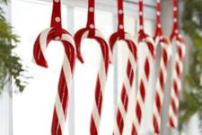 23 hang candy canes on the windows