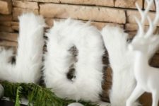 25 white fur letters for decorating a mantel