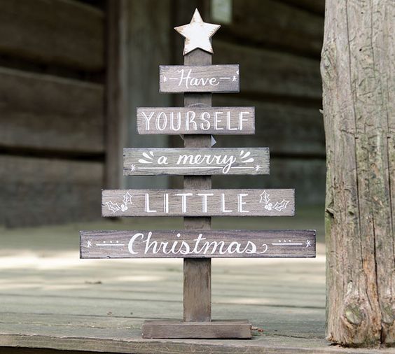 a natural wood slat small Christmas tree décor with a hand-painted white distressed star