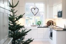 27 a non-decorated tree in a basket is ideal for a spacious minimalist kitchen