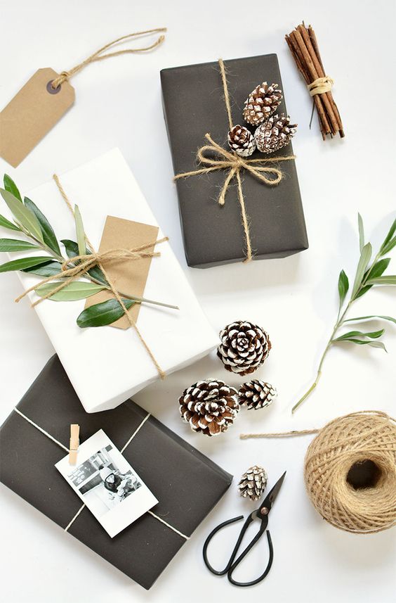 simple black or white wrapping paper looks amazing with twine, snowy pinecones and foliage