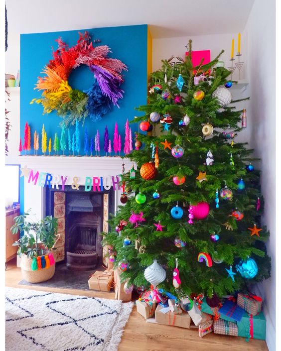 a Christmas tree decorated with colorful ornaments all over is amazing to make your space brighter