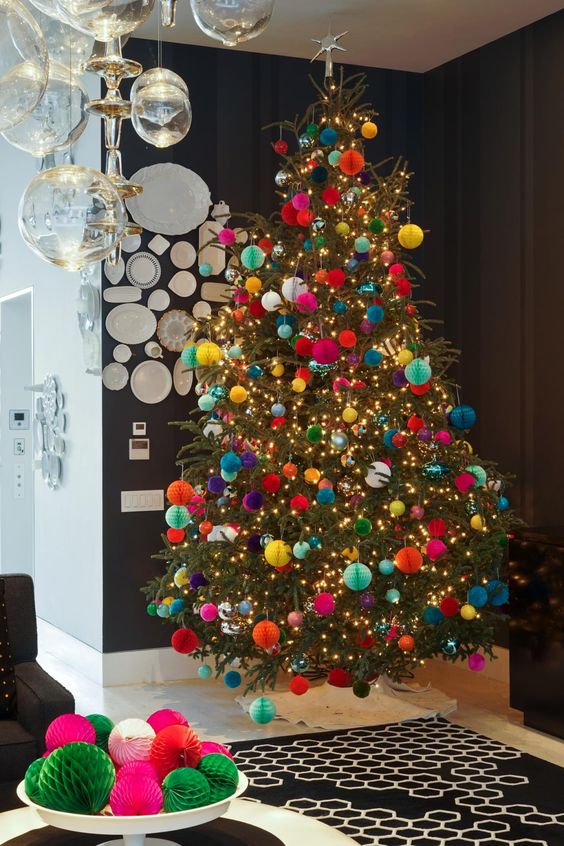 a colorful Christmas tree styled with bold paper ornaments and lights is a fantastic and very eye-catchy idea