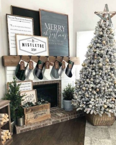 a cozy and chic farmhouse Christmas space with stockings, a neutral Christmas tree in a basket and artworks