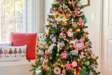 a fun Christmas tree decorated with colorful ornaments of all kinds and some toys is a cool idea for a kids’ room