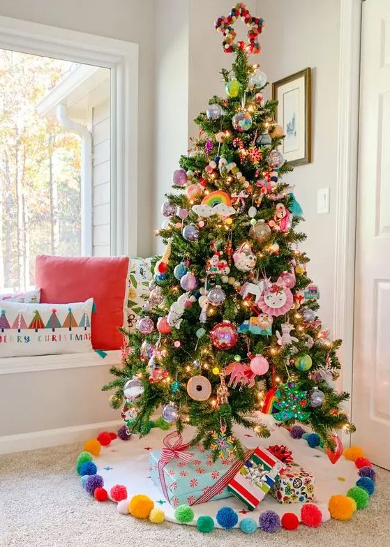 a fun Christmas tree decorated with colorful ornaments of all kinds and some toys is a cool idea for a kids' room