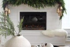 a modern Christmas centerpiece of a black bowl with mercury glass ornaments is a stylish idea for the space