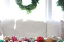 a primitive dough bowl filled with colorful vintage ornaments will be your perfect Christmas ornament display and decoration