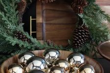 a simple timber bowl with shiny gold ornaments is a simple last-minute decoration to rock for the holidays