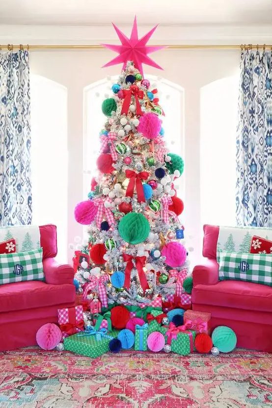 a super bright Christmas tree decorated with colorful paper pompoms and usual pompoms and bold ornaments