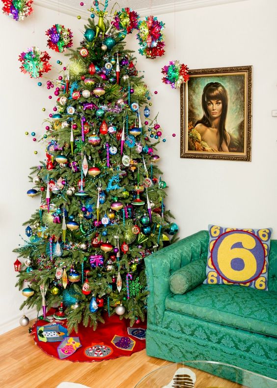 a super bright Christmas tree with very colorful ornaments and garlands plus bold beads and lights