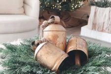 a vintage Christmas centerpiece of a wooden bowl, evergreens and vintage bells is a lovely arrangement