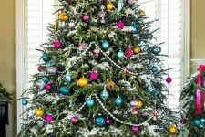 a vintage-inspired Christmas tree with beads, colorful ornaments of various shapes and a star on top