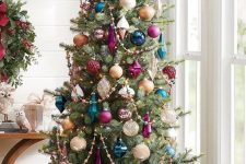 an elegant Christmas tree done with white, crystal, purple and navy ornaments and beads is a super cool solution