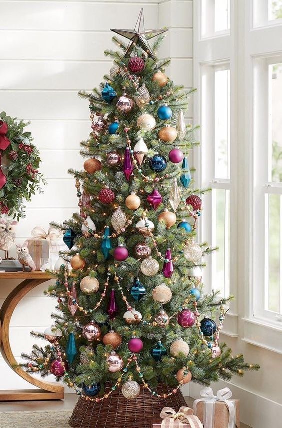 an elegant Christmas tree done with white, crystal, purple and navy ornaments and beads is a super cool solution