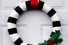 DIY duct tape wreath with holly berries and leaves