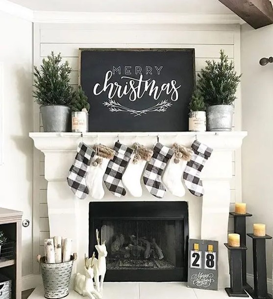plaid and faux fur stockings, evergreen trees in pots and a large chalkboard sign for a cozy neutral look