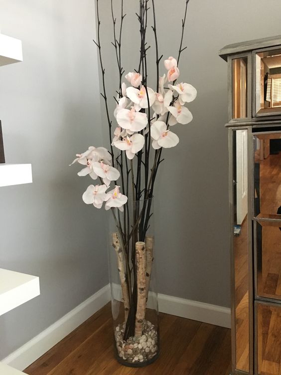 glass vase with birch branches and orchids