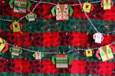 04 create an ugly sweater booth by decorating a using a large piece of plywood and decorating it with garish wallpaper and lights