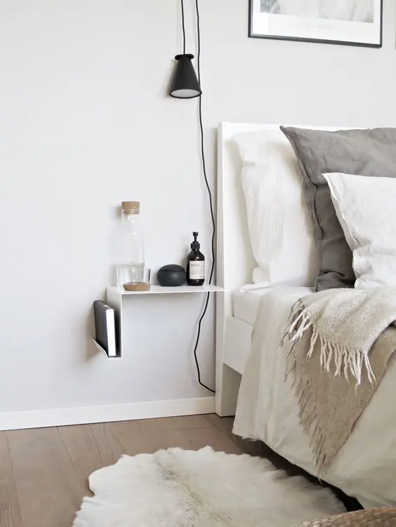 minimal metal sheet nightstand attached to the wall
