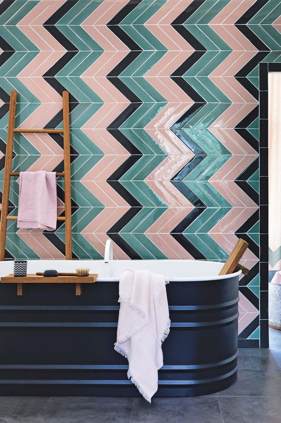 colorful green, black and pink tiles clad in a chevron pattern