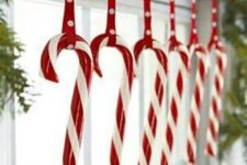 09 hang candy canes in kitchen window for an easy and joyous Christmas decorating idea