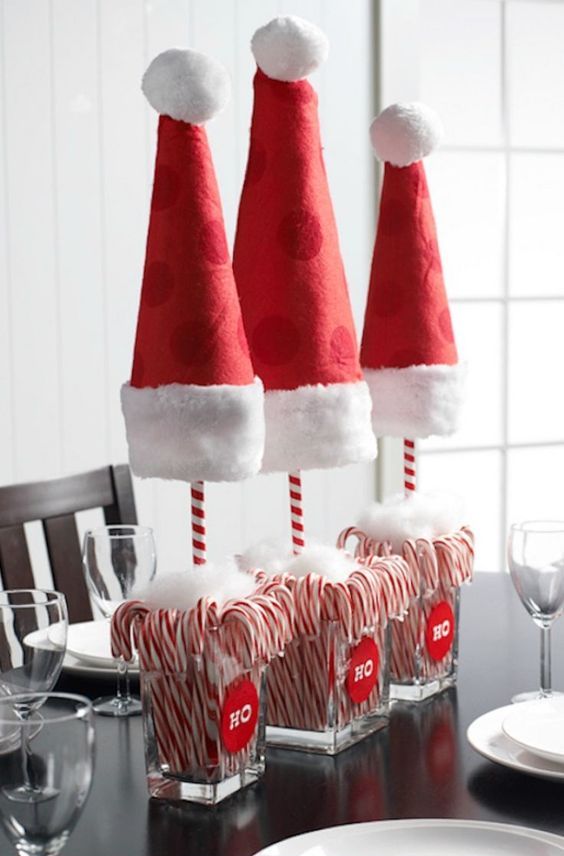Santa hat and candy canes topiaries as Christmas centerpieces
