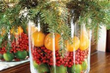 11 limes, cranberries and tangerines with evergreens for a rustic centerpiece