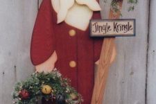 13 decorative Santa with an evergreen wreath and jingle bells