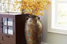 16 terra cotta floor vase with yellow leaves
