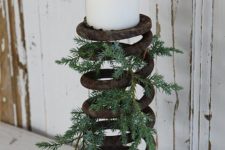 17 old rusted auto spring with greenery and a candle