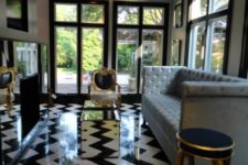 20 black and white floor tiles clad with a chevron pattern