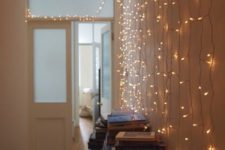23 drape string lights along a wall to make the whole place shimmer like the stars