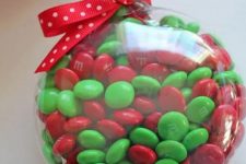 M&Ms fill ornament with a red bow is a lovely Christmassy idea in traditional colors, and it’s very easy to make