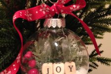 a Christmas ornaments with faux snow, cranberries, evergreens and letters is a lovely solution for the holidays