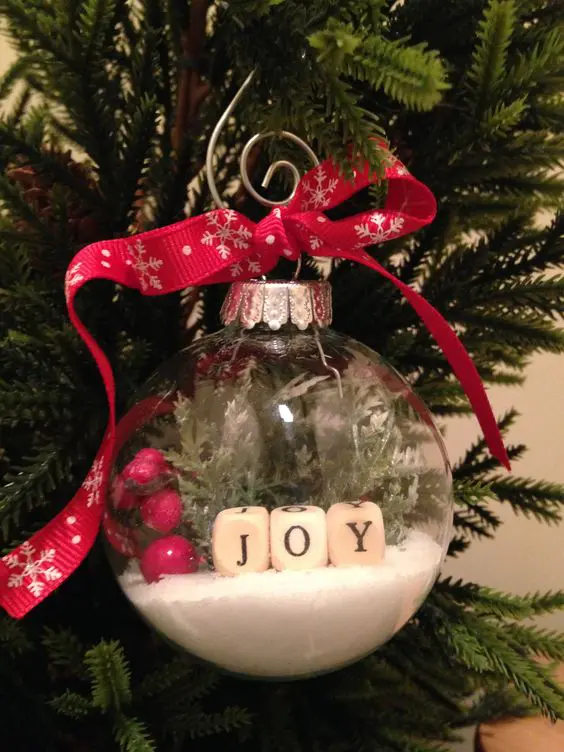 a Christmas ornaments with faux snow, cranberries, evergreens and letters is a lovely solution for the holidays
