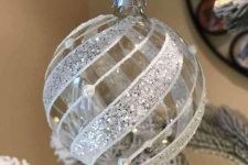 a clear Christmas ornaments with shiny white ribbons is a very festive and cool decoration to rock