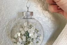a clear glass Christmas ornament filled with baby’s breath is a lovely idea for boho Christmas decor