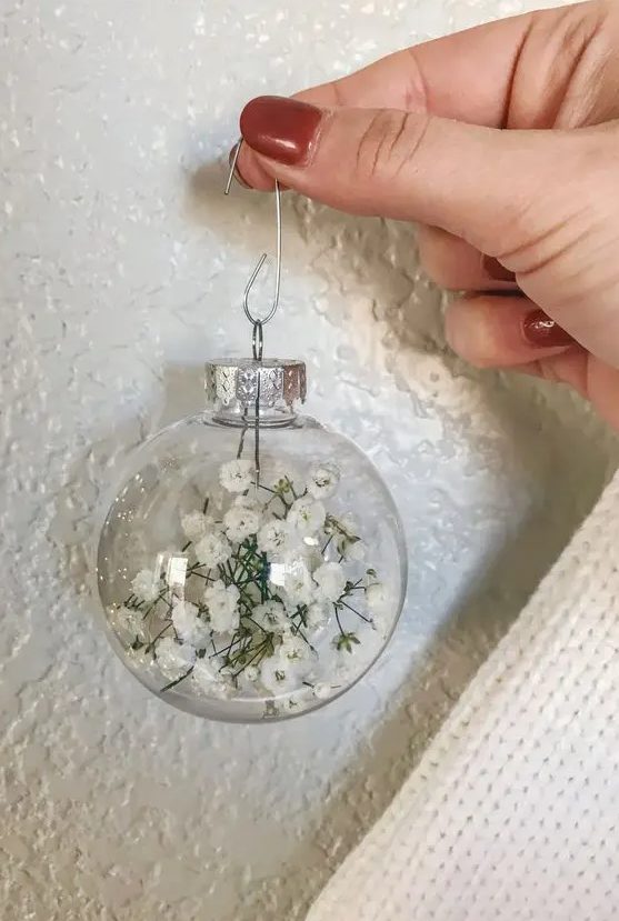 a clear glass Christmas ornament filled with baby's breath is a lovely idea for boho Christmas decor