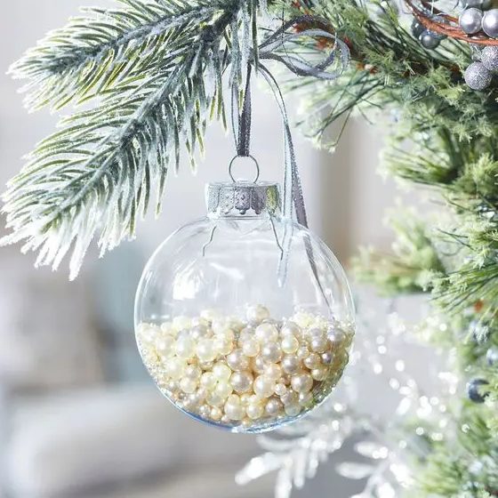 a clear glass Christmas ornament filled with pearls is a glam and chic idea with a vintage feel